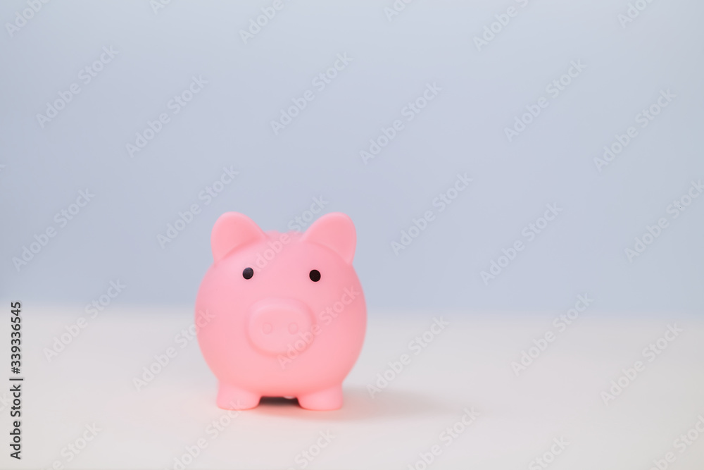 Pink toy pig on light blue background, copy space. Rosy piggy bank. Moneybox, thrift-box mockup. Savings money concept