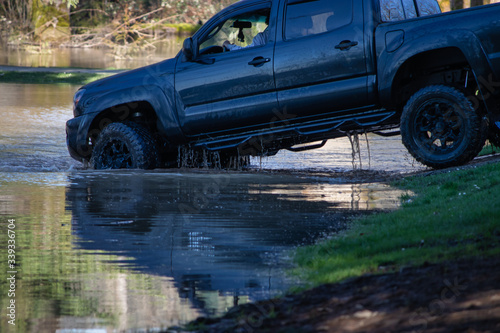 a black truck backing out of flooded park