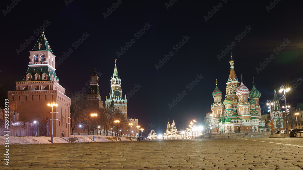 Obraz premium Moscow, Russia - March 9, 2019: Red Square. Spring night. Spasskaya Tower, Red Kremlin wall, Saint Basil's Cathedral / Cathedral of Vasily the Blessed, facade of GUM (department store). Stone pavement