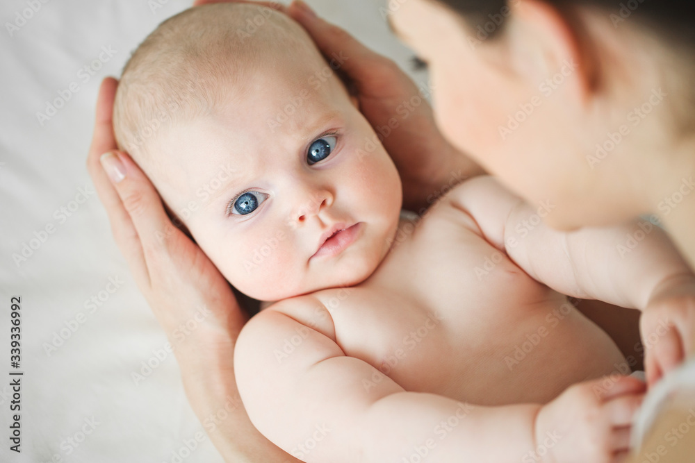 Woman with a baby on a white background. Mom holds the baby. Woman with a baby on a white background. Mom holds the baby.