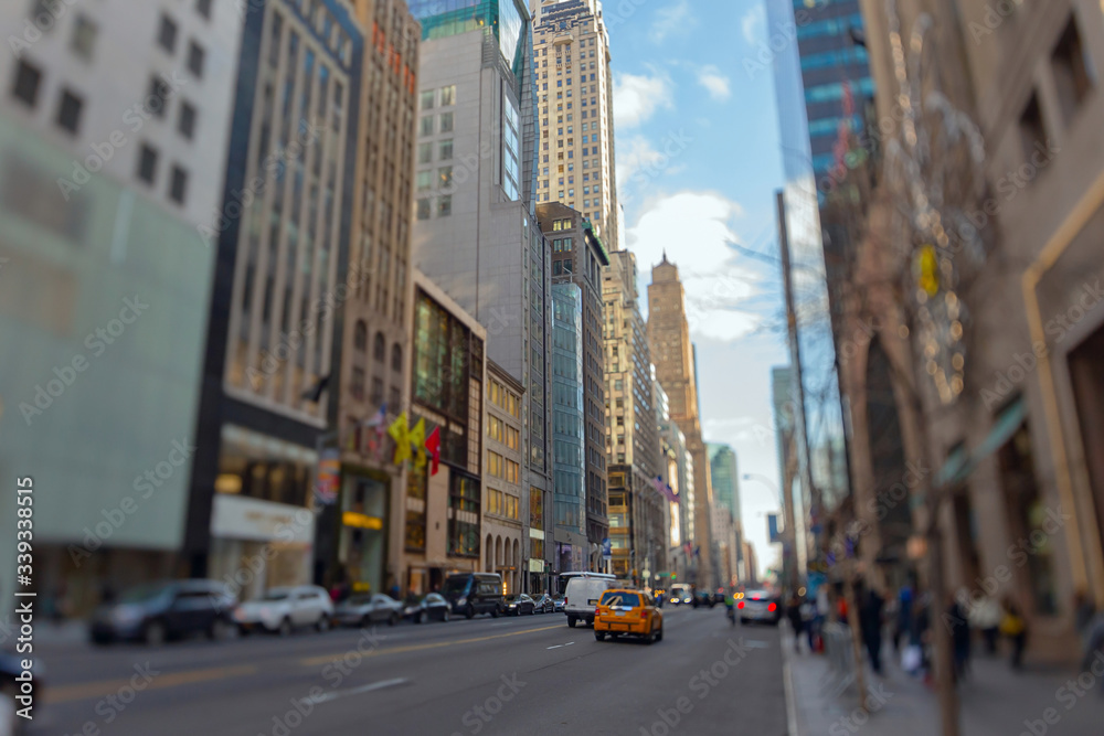 Naklejka premium Street view of light traffic in a New York City street. Shot with manual Tilt Shift lens for selective focus effect.