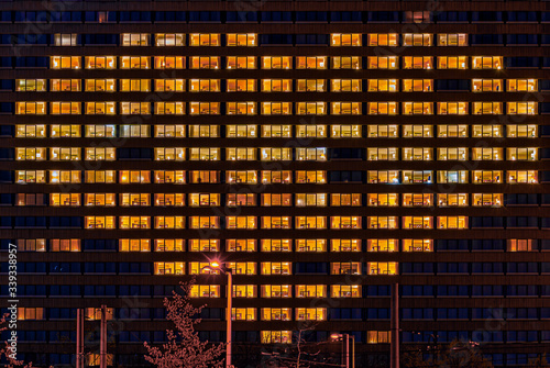 Heart shape illuminated windows of a building as a gesture for people who support others like now in hard corona virus times symbolically.