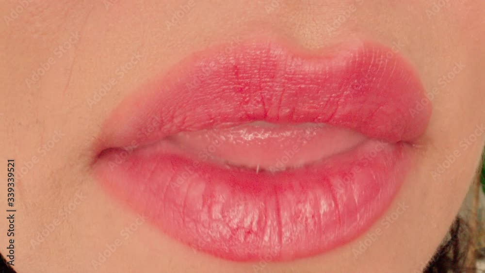 Extreme macro close up of woman lips kissing smiling and licking sexy white teeth shot in 4k Extreme macro close up of woman lips kissing smiling and licking sexy white teeth shot in 4k