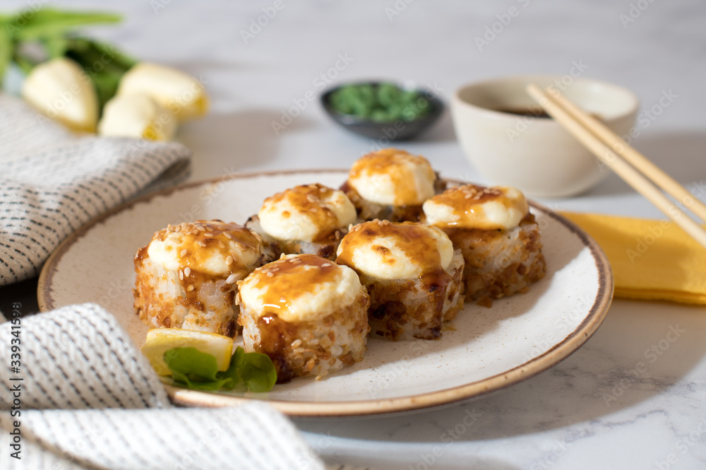 Top view on the plate of baked rolls with sauce Top view on the plate of baked rolls with sauce