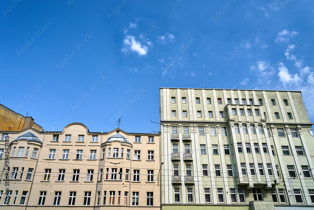 Facades of historic tenement houses on a sunny day in the city of Poznan..
