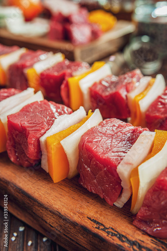 Raw meat stick with ingredients in close-up - Brazilian espetinho de carne photo