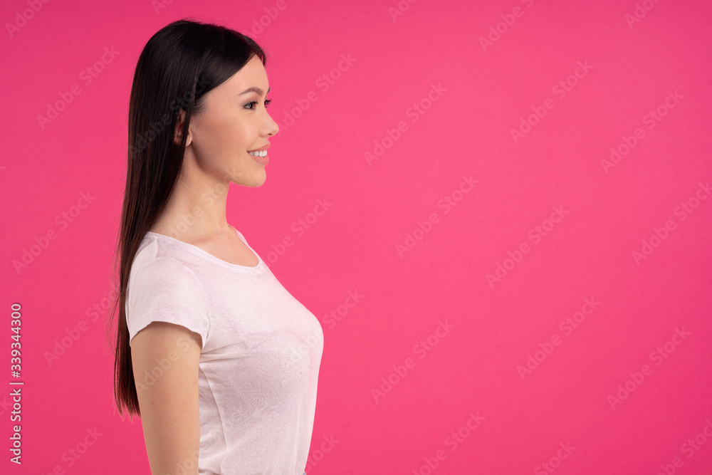 Profile shot of happy Asian female student , white casual wear, smiles gently at camera, satisfied after successful day at university, dressed in summer white t shirt. Profile shot of happy Asian female student , white casual wear, smiles gently at camera, satisfied after successful day at university, dressed in summer white t shirt.