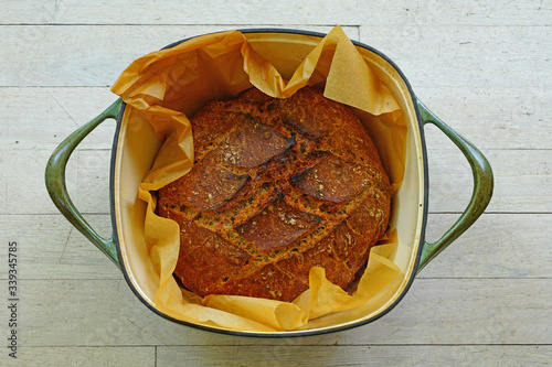 Εκτύπωση καμβά Loaf of crusty miracle overnight no knead bread baked on parchment paper in a Du