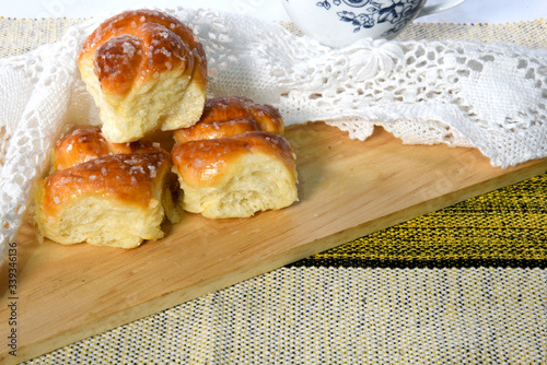 Sweet bread, typical of the Brazilian bakery, on the table on white background with space for text. It has the name of Rosca. photo