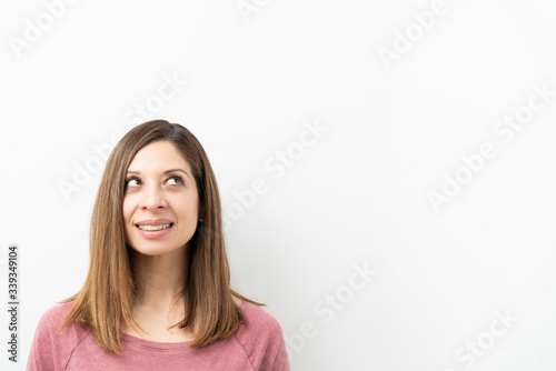 Cute brunette woman looking at copy space