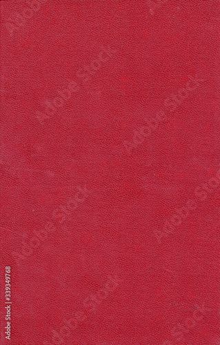 Artificial leather texture. Red old book cover. Rough surface with embossed. Blank retro page. Empty place for text. Perfect for background and vintage style design.