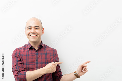 Friendly guy pointing towards copy space
