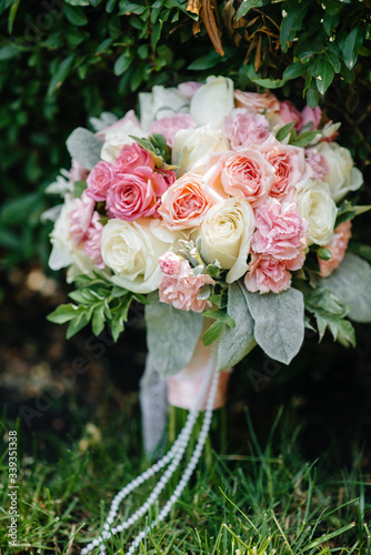 Beautiful wedding bouquet on the green grass on a summer day