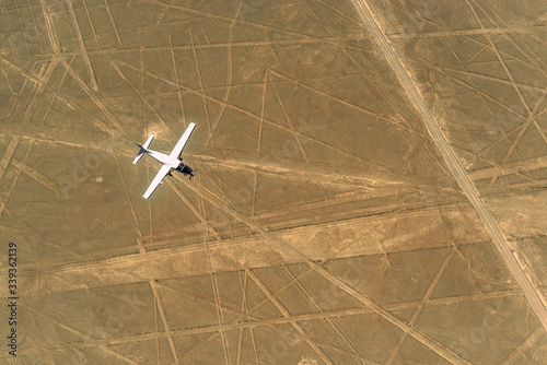 Tableau sur toile An aircraft flying over the Nazca Lines with tourists, Peru.
