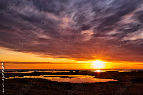 Majestic sunset with clouds in moviment reflected in the water