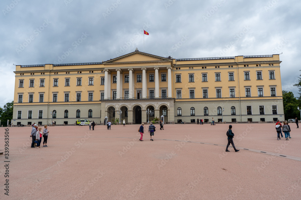People walking around The Royal Palace of Oslo in Norway. August 2019