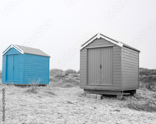 Findhorn, Scotland - July 2016: Colourful beach huts along the coast at Findhorn Bay in Northern Scotland among the sand dunes