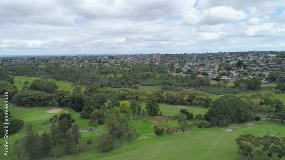 Slow aerial descend over park and golf course Slow aerial descend over park and golf course