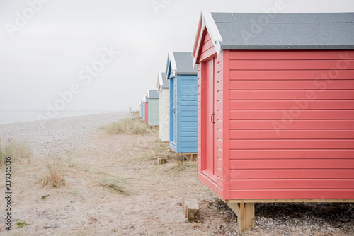 Fotografie Findhorn, Scotland - July 2016: Colourful beach huts along the coast at Findhorn