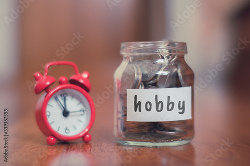 Hobby savings concept - Glass jar with coins and inscription. photo