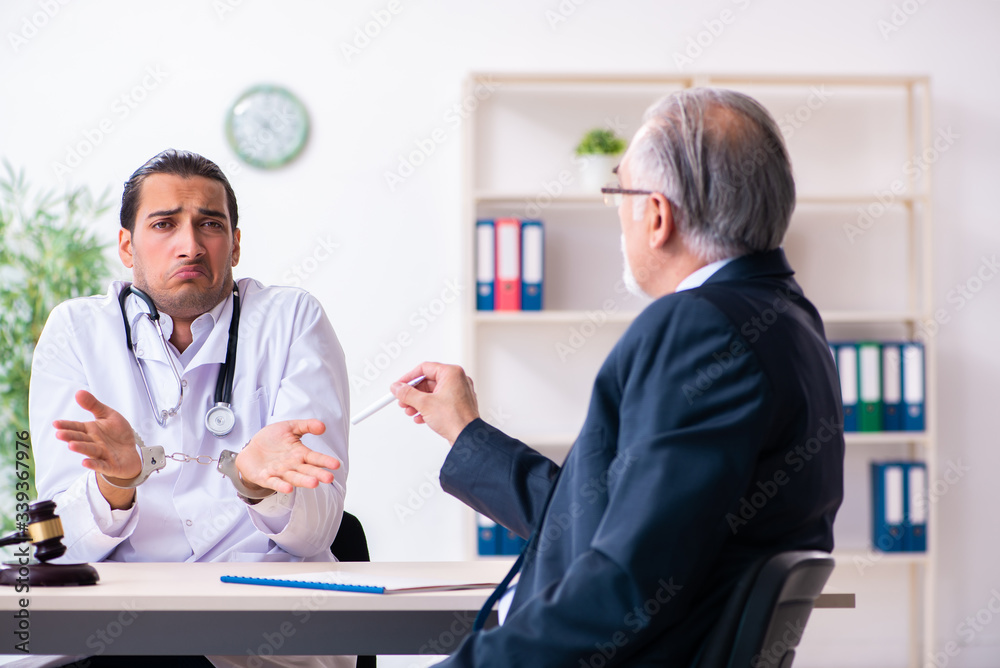 Fototapeta premium Male doctor in courthouse meeting with lawyer