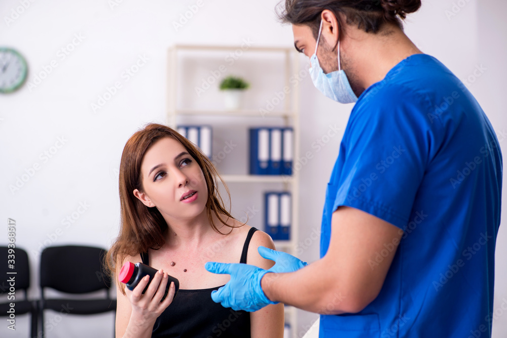 Young woman visiting male doctor dermatologist Young woman visiting male doctor dermatologist