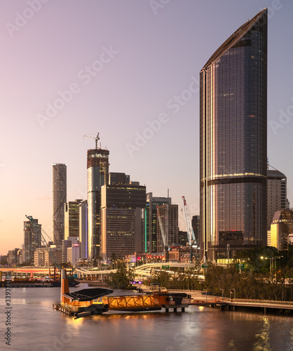 Brisbane river city at sunset with a beautiful glow and city cat travel terminal dock