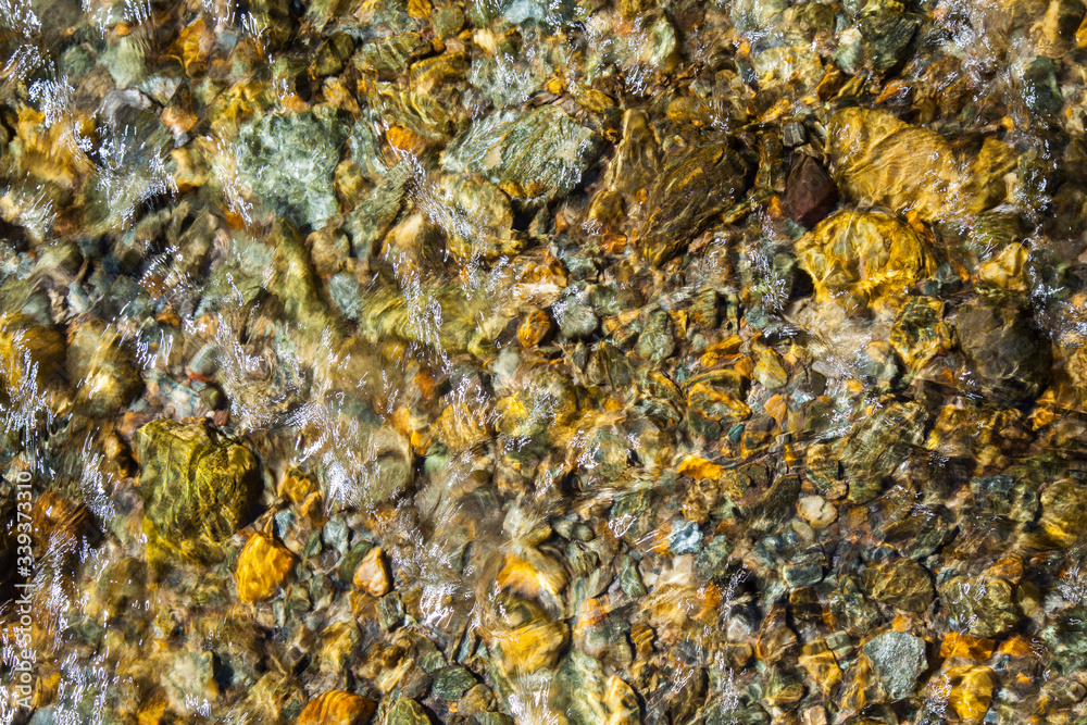 Beautiful stones on the bottom of a clean river, natural background