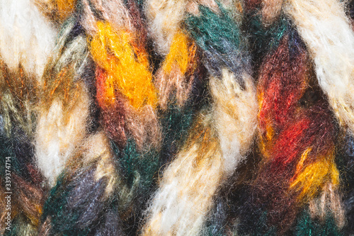 Colorful wool yarn. woolen fabric background. knitted textile © maxkolmeto