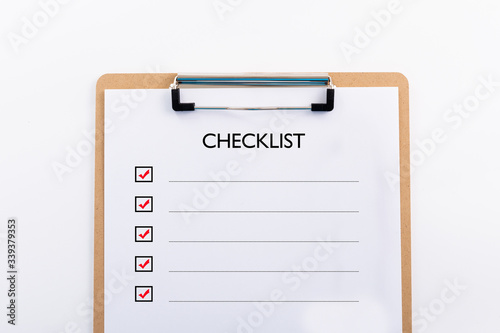 "CHECKLIST" concept. Note pad and white paper on white background, copy space