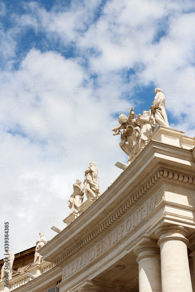 A group of Saint Statues on the colonnades of St Peter's Square with blue sky and clouds in Vatican City, Rome, Italy