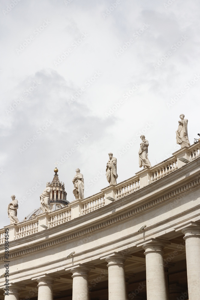 A group of Saint Statues on the colonnades of St Peter's Square with clouds in Vatican City, Rome, Italy