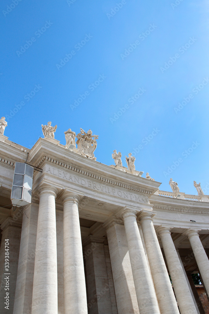 A group of Saint Statues on the colonnades of St Peter's Square with blue sky and clouds in Vatican City, Rome, Italy