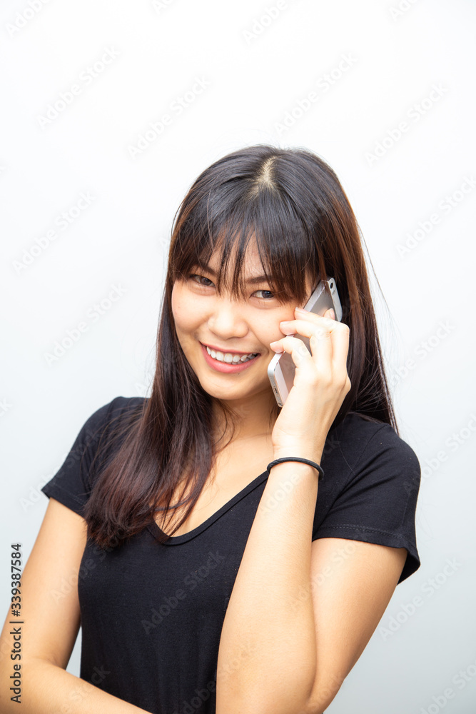 Portrait of asian smiling casual woman holding smartphone Portrait of asian smiling casual woman holding smartphone