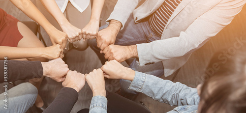 Fotografie Creative team meeting fist bumps circle, hands together, asian people teamwork acquisition, brainstorm business people concept
