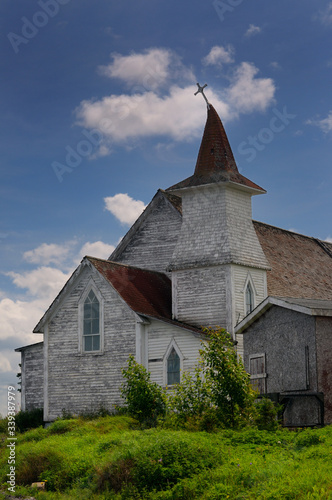 Принти на полотні Anglican Christ Church with bent steeple and cross at Clarke's Head Gander Bay N