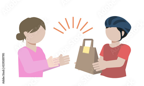A delivery staff pass a paper bag.