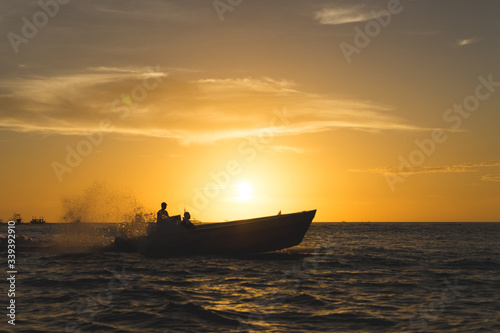 Speeding speed boat at sunset
