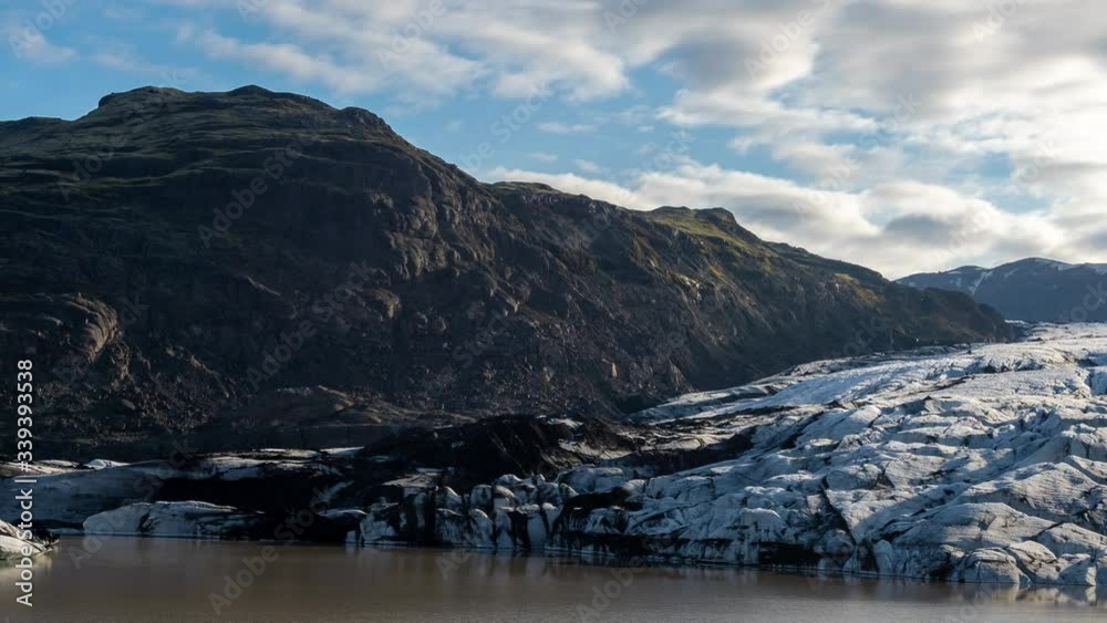 Svinafellsjokull Glacier, Iceland. Timelapse of Clouds Moving Over Volcanic Hills, Ice and Glacial Lake Svinafellsjokull Glacier, Iceland. Timelapse of Clouds Moving Over Volcanic Hills, Ice and Glacial Lake