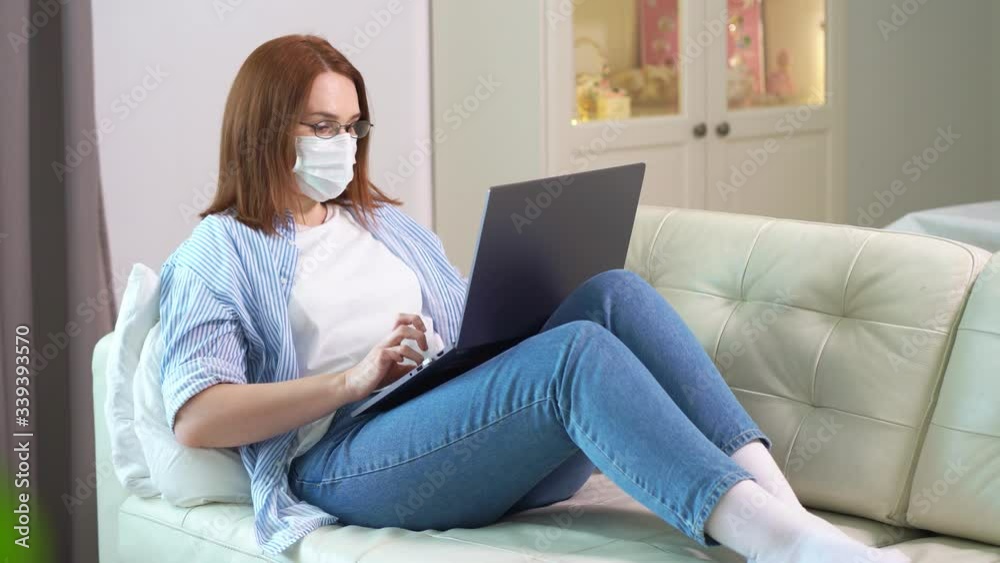 woman freelancer in mask work lying with computer woman freelancer in mask work lying with computer