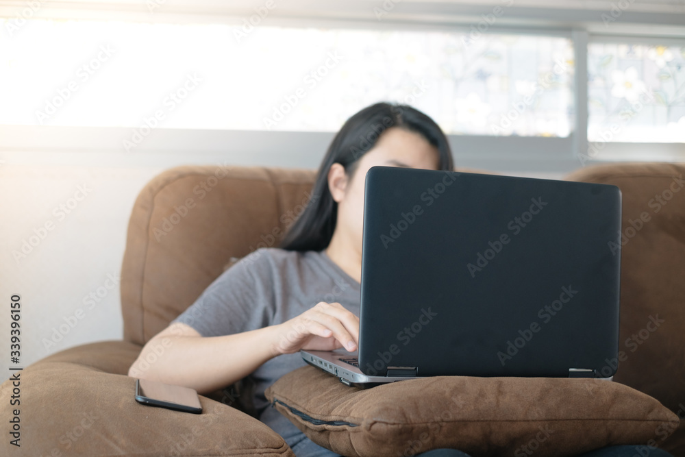 Naklejka premium Asian women use laptop working at home for protect COVID-19