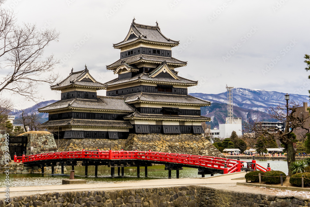 Matsumoto Castle (Matsumoto-jo) and red bridge foreground in eastern Honshu, Matsumoto-shi, Chubu, Nagano, Japan. a Japanese premier historic castles Matsumoto Castle (Matsumoto-jo) and red bridge foreground in eastern Honshu, Matsumoto-shi, Chubu, Nagano, Japan. a Japanese premier historic castles