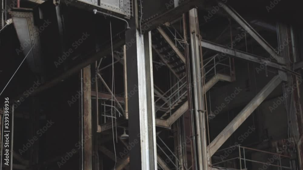 Inside The Abandoned Industrial Building With Steel Beams And Rusty Stairs.-tilt p shot Inside The Abandoned Industrial Building With Steel Beams And Rusty Stairs.-tilt p shot