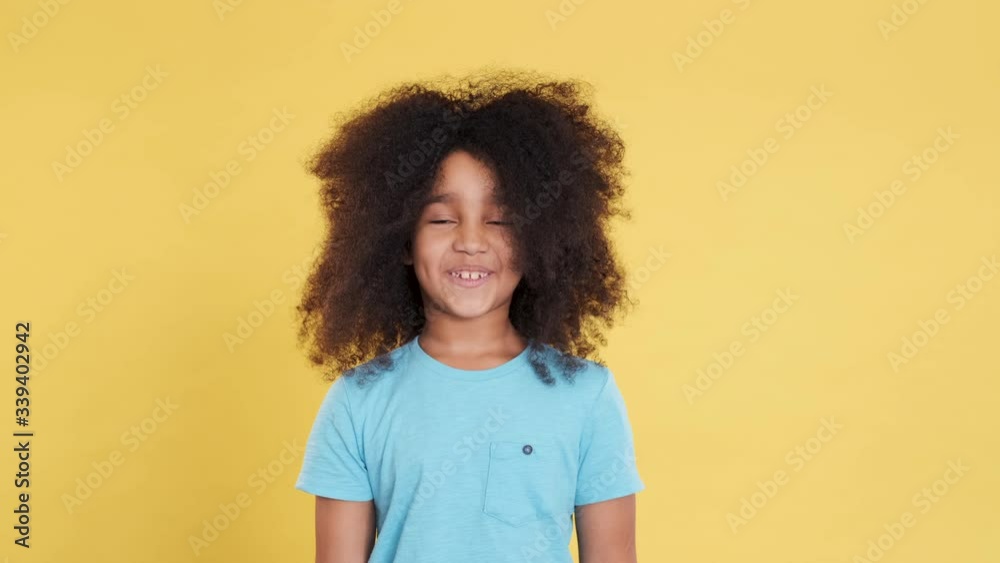 Jocular or Ridiculous Face of Little Dark-skinned Girl with Curly Lush Hair. Amusing and Idiotic Facial Expressions. Imagine Fish Face. Emotional and Artistic Kid Have Fun and Shows Parody. Closeup Jocular or Ridiculous Face of Little Dark-skinned Girl with Curly Lush Hair. Amusing and Idiotic Facial Expressions. Imagine Fish Face. Emotional and Artistic Kid Have Fun and Shows Parody. Closeup