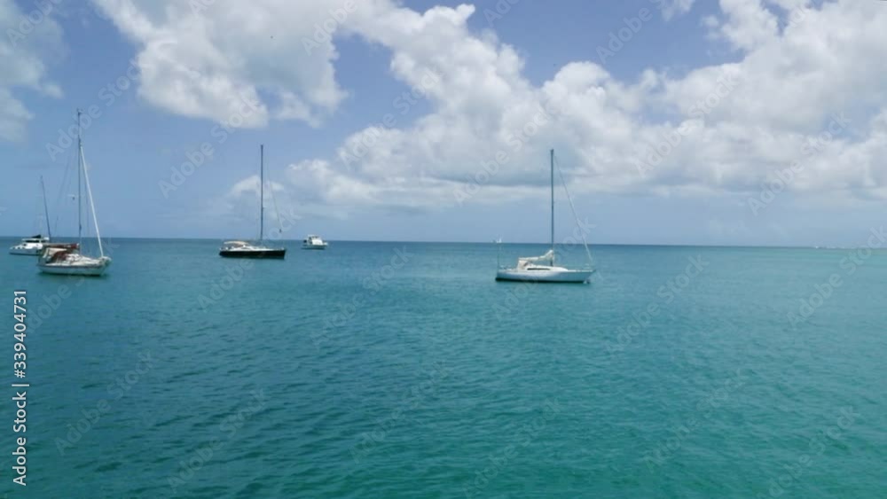 Boats anchored in the middle of the Caribbean off shore from Tobago, West Indies. Boats anchored in the middle of the Caribbean off shore from Tobago, West Indies.