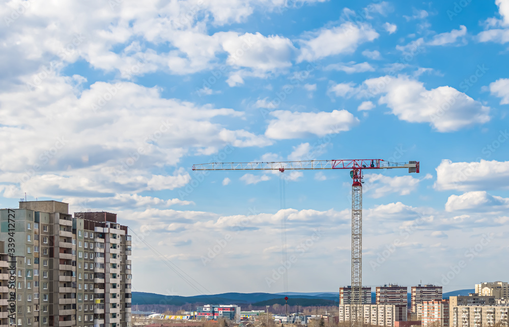 construction crane on a sky background. clouds construction crane on a sky background. clouds