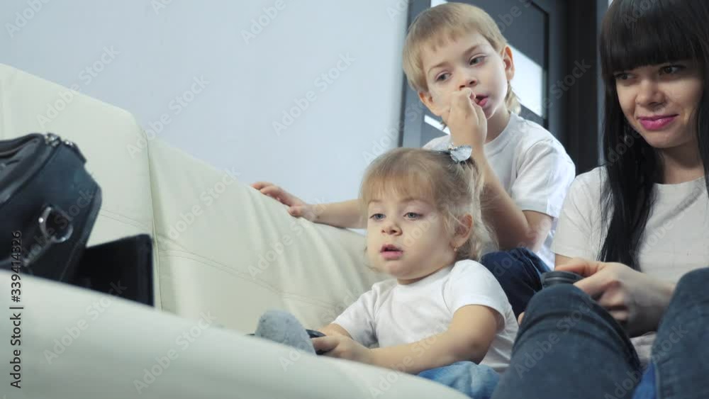 mother and children play console in gamepads teamwork. mom and kids a boy and a girl are playing a portable set-top box in TV controller. happy family little boy and girl lifestyle have online fun mother and children play console in gamepads teamwork. mom and kids a boy and a girl are playing a portable set-top box in TV controller. happy family little boy and girl lifestyle have online fun