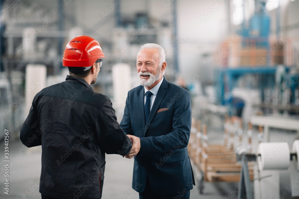 Colleagues working together. Arhitect and worker in factory. Colleagues working together. Arhitect and worker in factory.