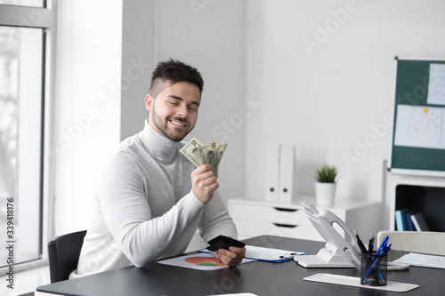 Man counting money in office
