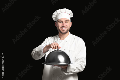 Handsome male chef on dark ...